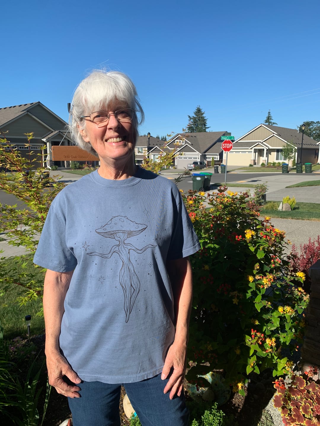 Linda outdoors wearing her Dancing Mushroom tee