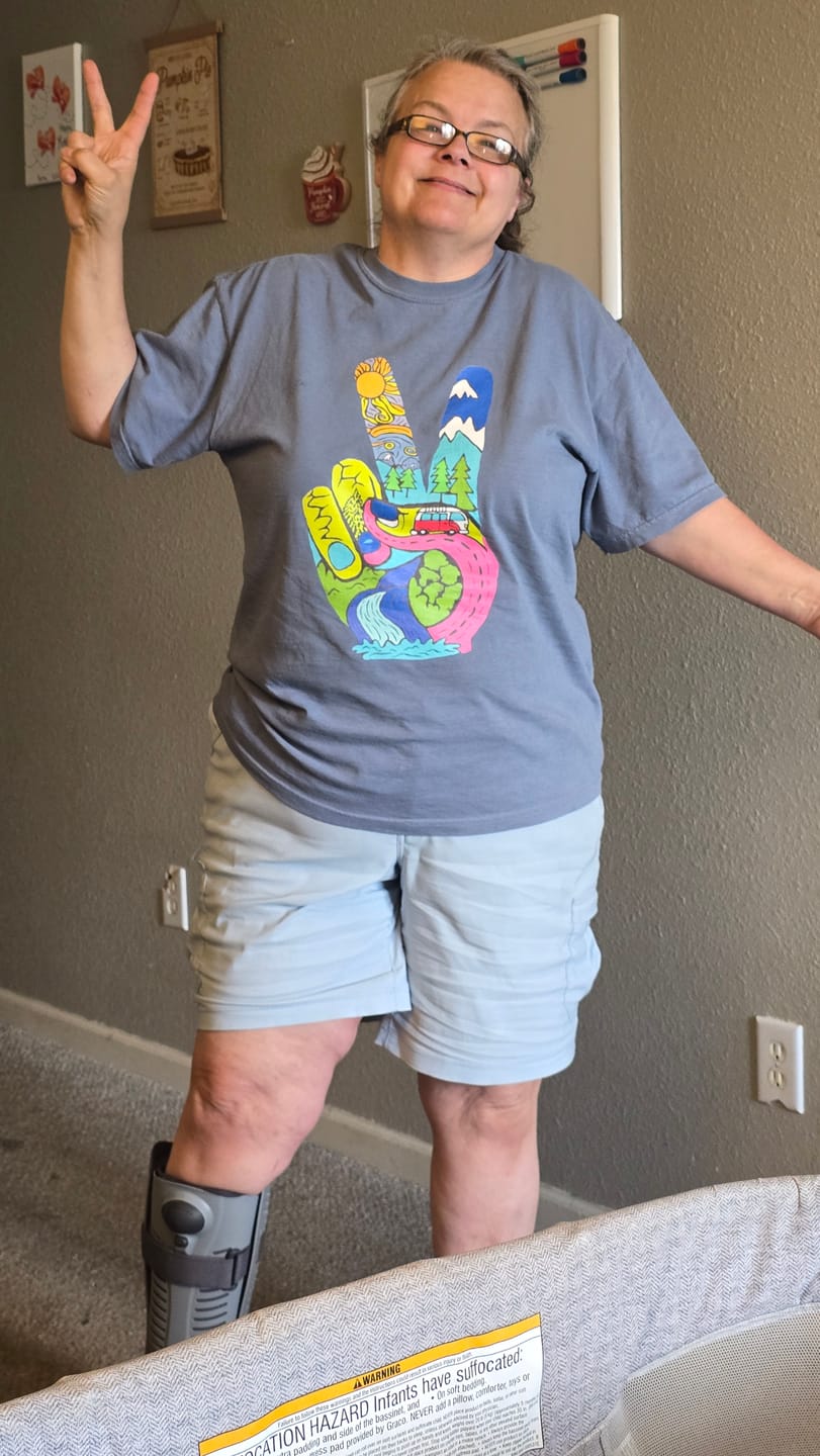 Michelle wearing her Funky Peace tee and holding up a peace sign