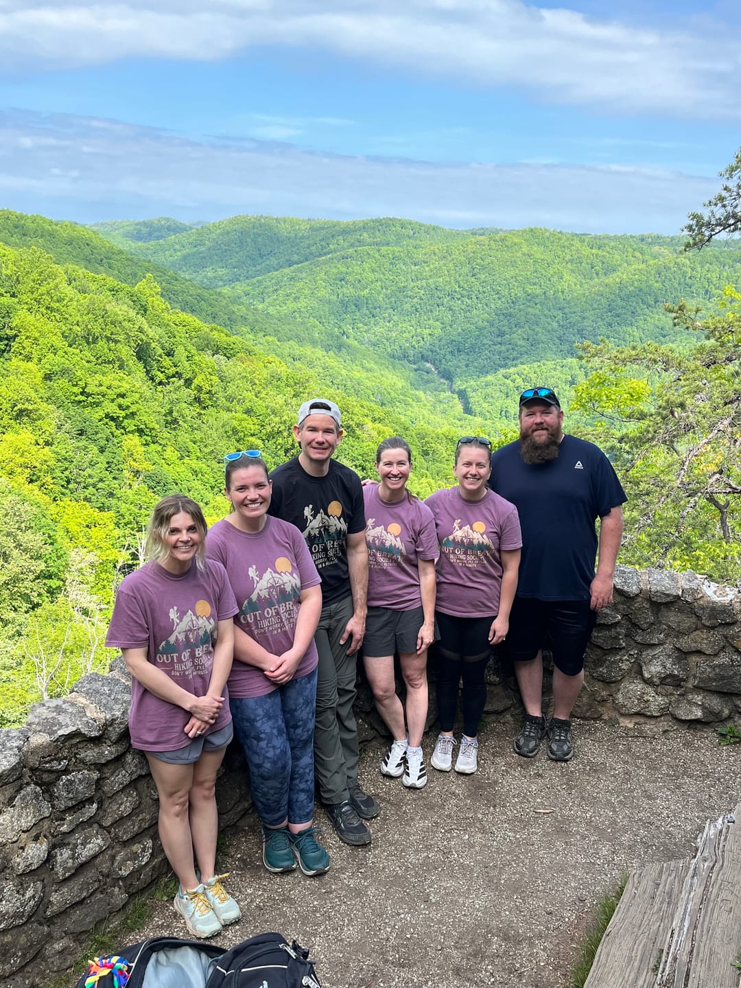 Patricia and friends wearing matching Out Of Breath tees on a birthday hike